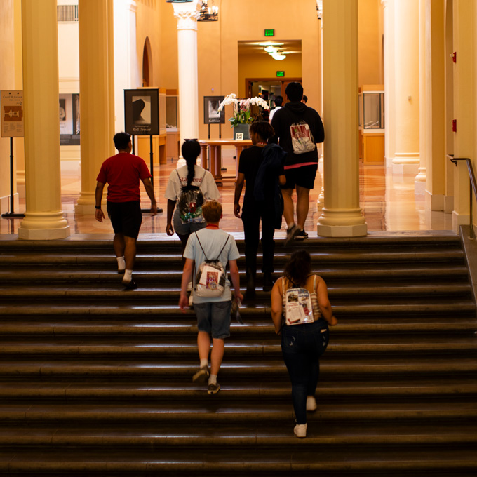 Student walking up steps inside the library