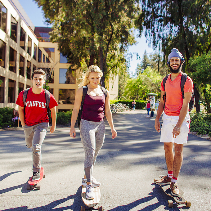 Three students on skateboards